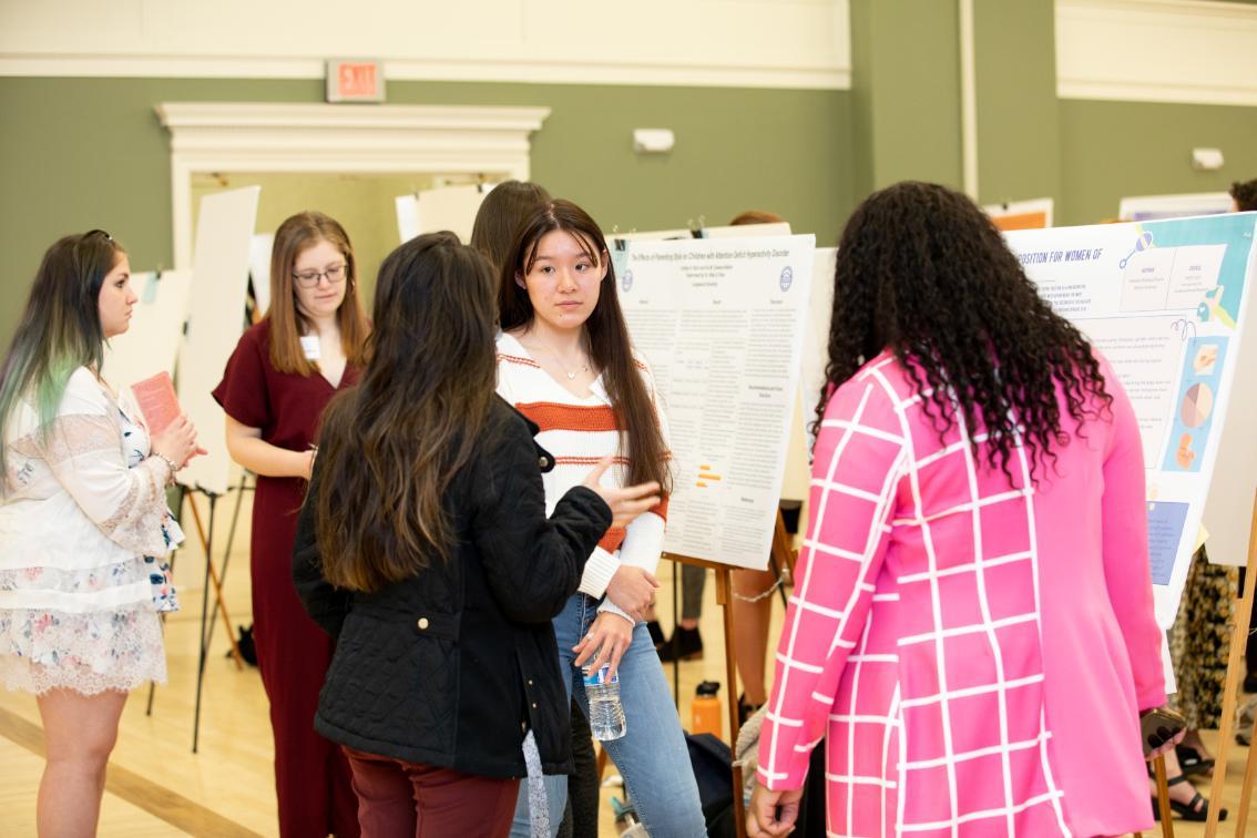 Isabella Kohama-Flores '23 and Anaya Jennings'23 present their poster