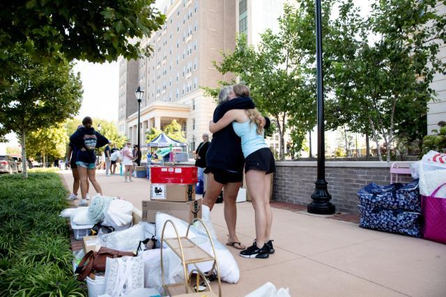 A hug outside halls during move-in 2024